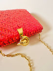 Borsa in midollino color geranio con chiusura a nodo e catena dorata “Rodo”