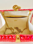Borsa in midollino color geranio con chiusura a nodo e catena dorata “Rodo”