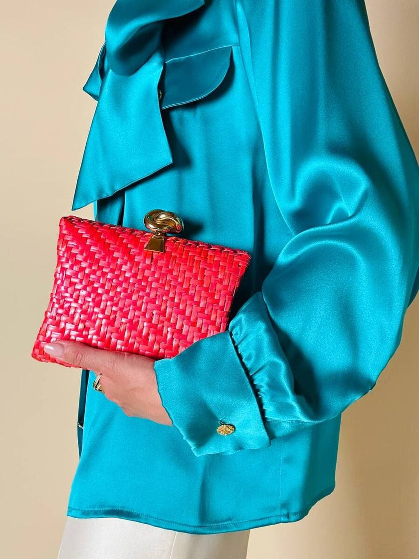 Borsa in midollino color geranio con chiusura a nodo e catena dorata “Rodo”
