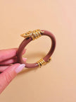 Bracciale rigido rosa antico con serpenti dorati
