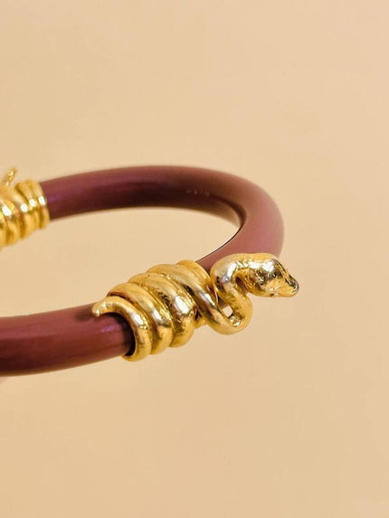 Bracciale rigido rosa antico con serpenti dorati