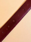 Cintura in pelle bordeaux con hardware oro 