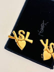 Clip dorate con cuore e iniziali YSL 