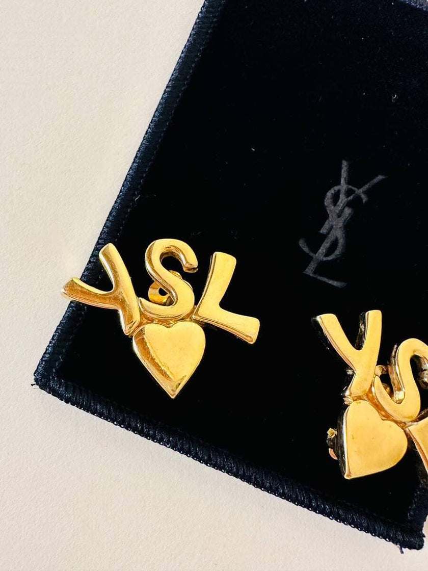 Clip dorate con cuore e iniziali YSL 