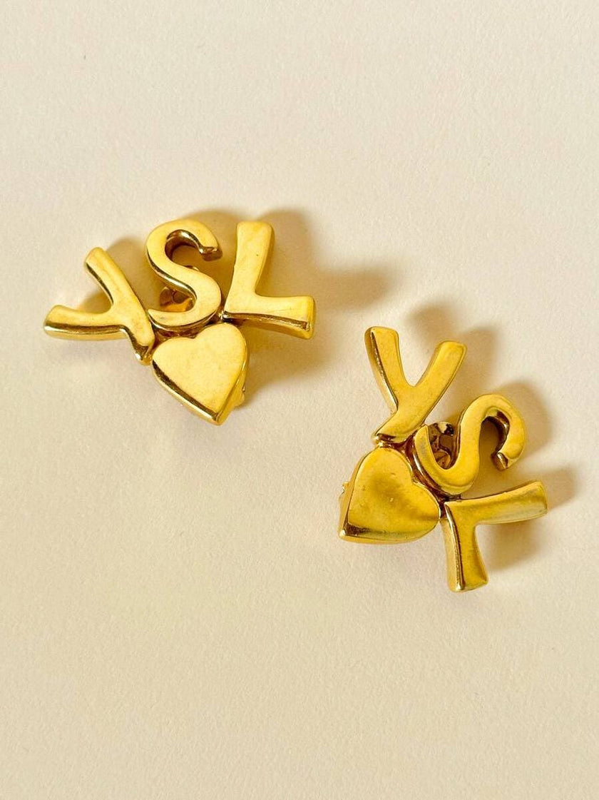 Clip dorate con cuore e iniziali YSL 