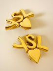 Clip dorate con cuore e iniziali YSL 