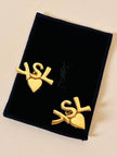 Clip dorate con cuore e iniziali YSL 