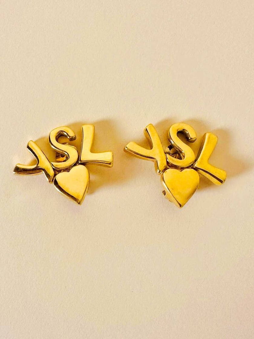 Clip dorate con cuore e iniziali YSL 