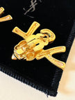 Clip dorate con cuore e iniziali YSL 