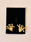 Clip dorate con cuore e iniziali YSL 