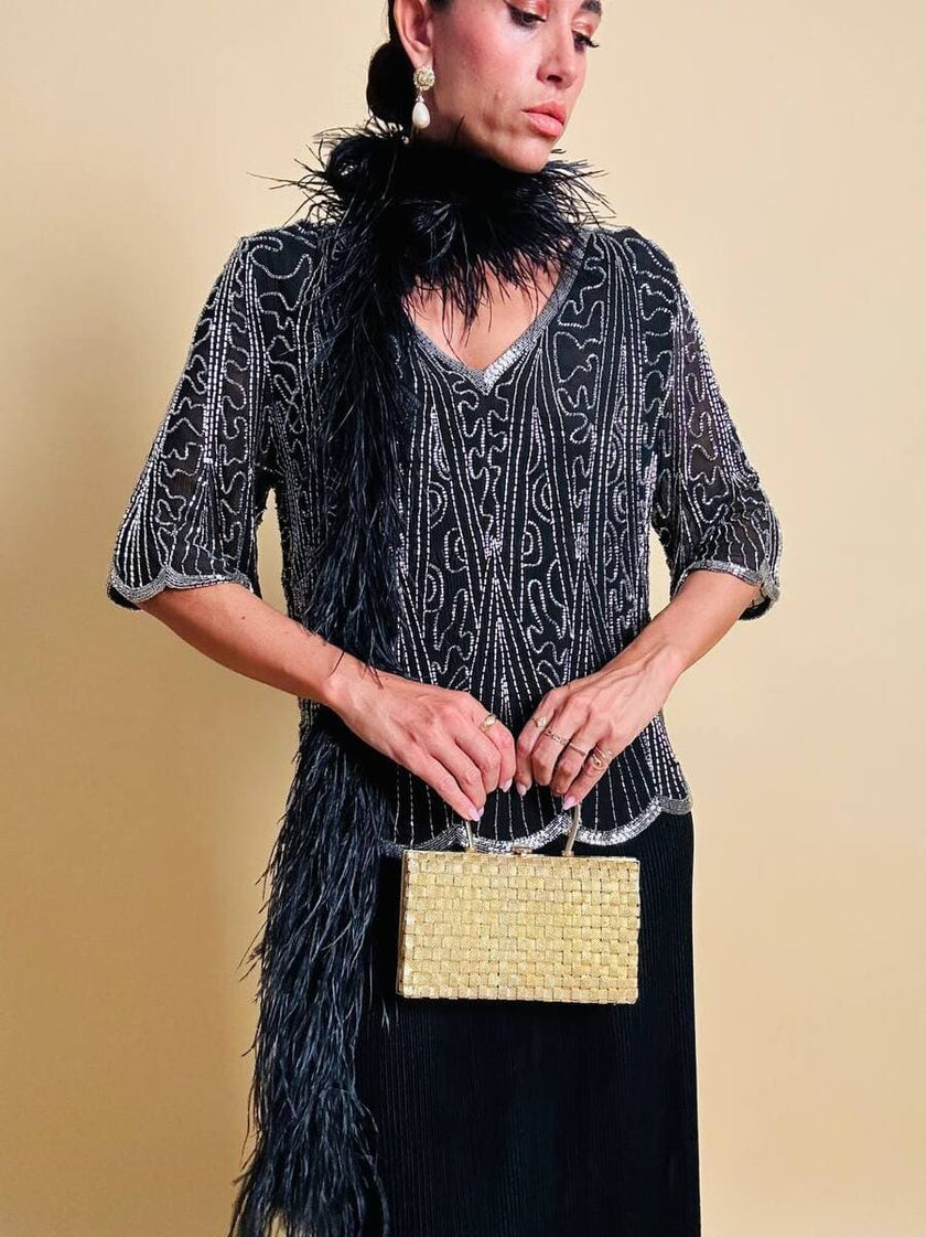 Clutch in metallo oro con motivo a intreccio