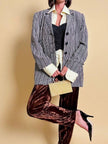 Clutch in metallo oro con motivo a intreccio