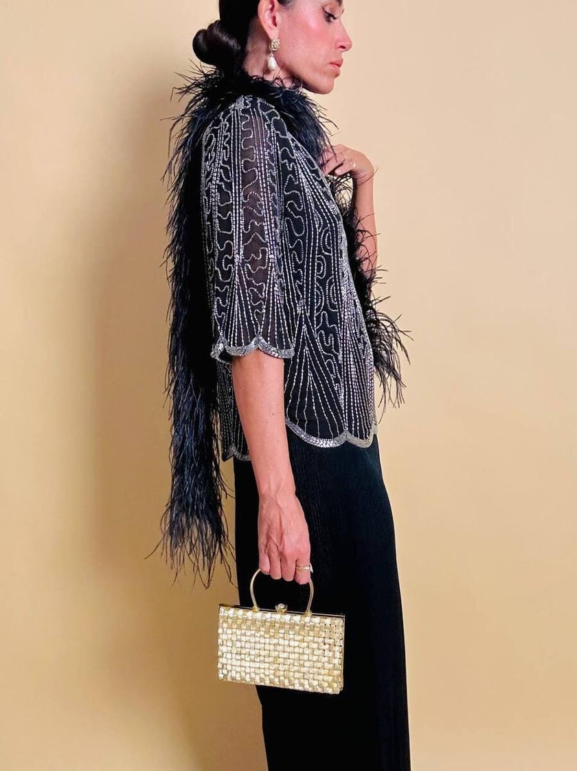 Clutch in metallo oro con motivo a intreccio