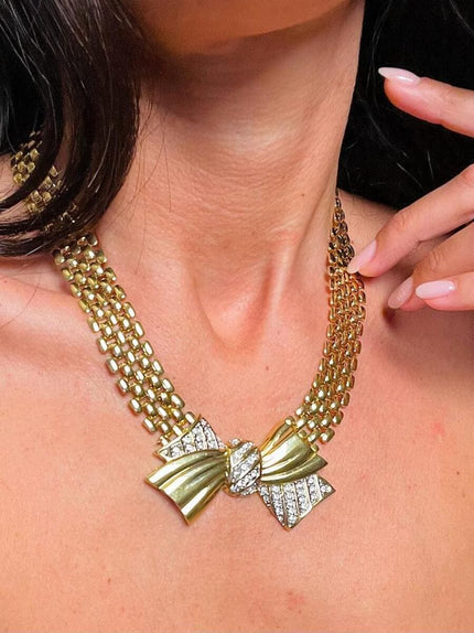 Collier dorato con maxi fiocco