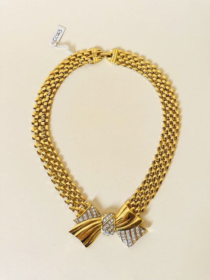 Collier dorato con maxi fiocco