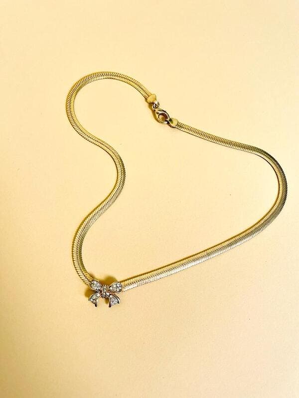 Collier dorato con fiocco di strass