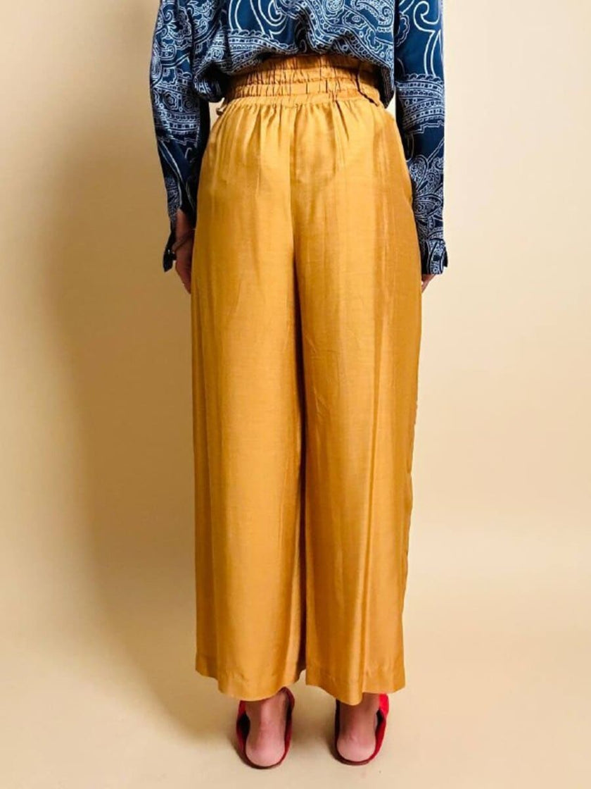 Pantalone chino con piega asimmetrica e soffietto plissé giallo indiano