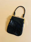 Mini bag artigianale in pitone nero con fodera rossa
