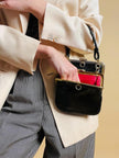Mini bag artigianale in pitone nero con fodera rossa