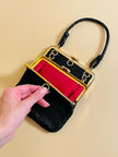 Mini bag artigianale in pitone nero con fodera rossa