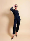 Smoking jumpsuit nera con bottoni dorati