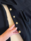 Smoking jumpsuit nera con bottoni dorati