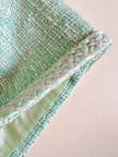 Tailleur sartoriale haute couture in tweed verde acqua marina con maxi bottoni gioiello