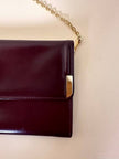 Pochette in pelle spazzolata bordeaux con tracolla in catena