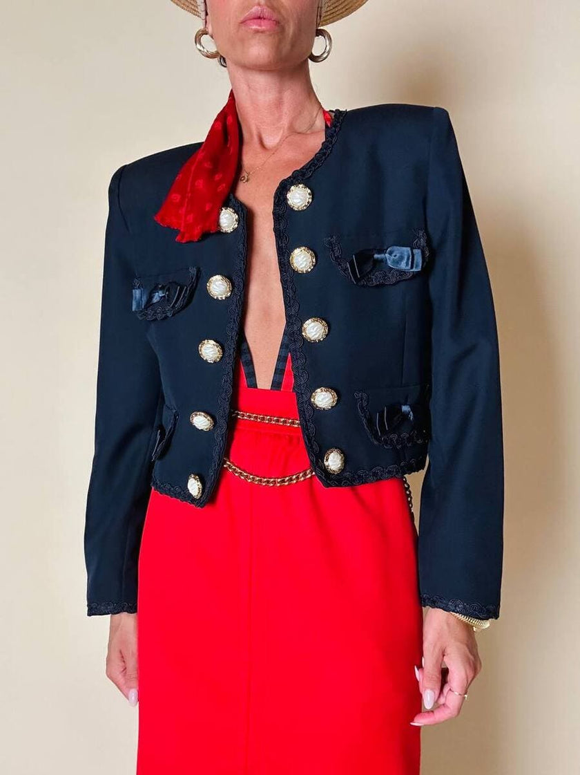Bolero blu con bottoni gioiello e fiocchi “Max Dinè”