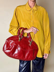 Borsa in pelle rosso bruciato con manici a treccia