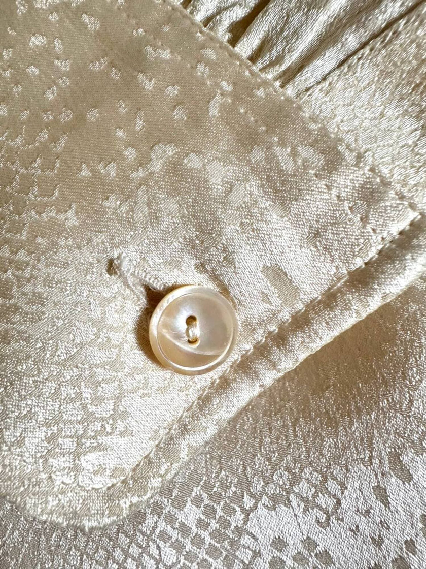 Blusa Yves Saint Laurent con fiocco al collo in seta jacquard avorio fantasia pitone