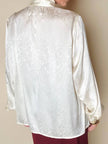 Blusa Yves Saint Laurent con fiocco al collo in seta jacquard avorio fantasia pitone