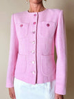 Blazer in lana bouclé rosa con bottoni gioiello logati in madreperla “Yves Saint Laurent”