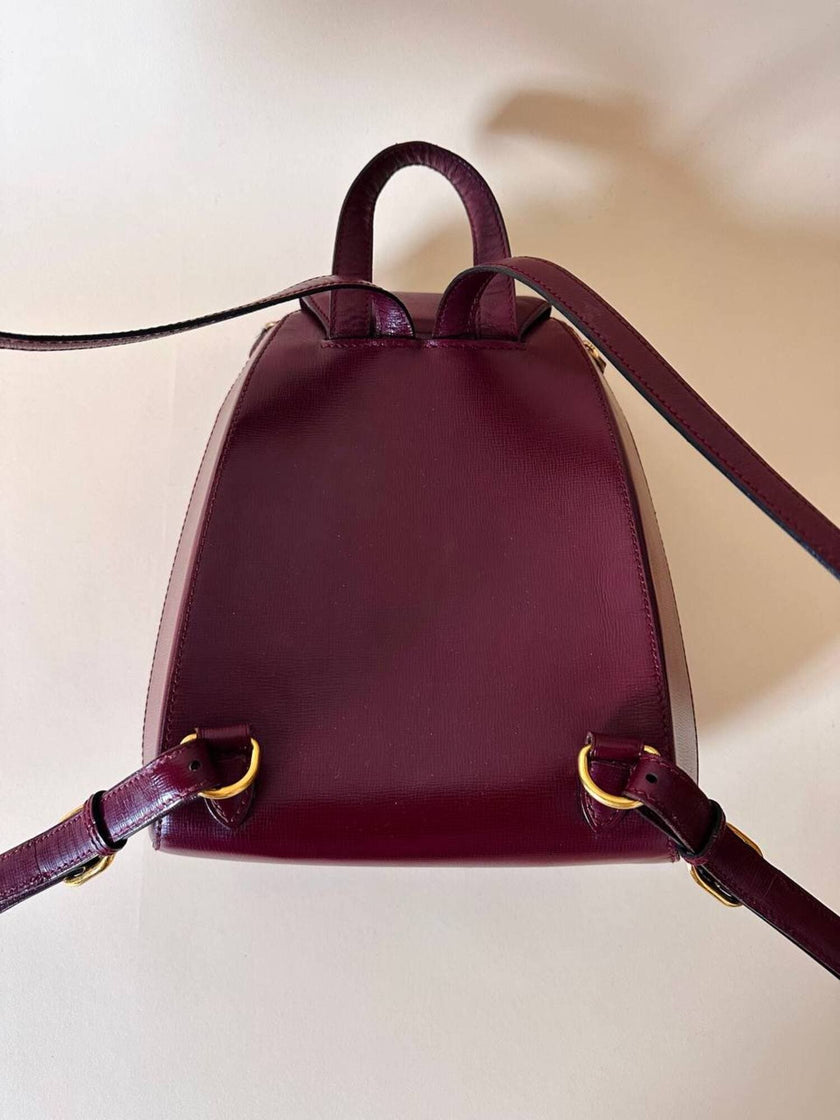 Sac à dos Must de Cartier en cuir bordeaux avec finitions dorées