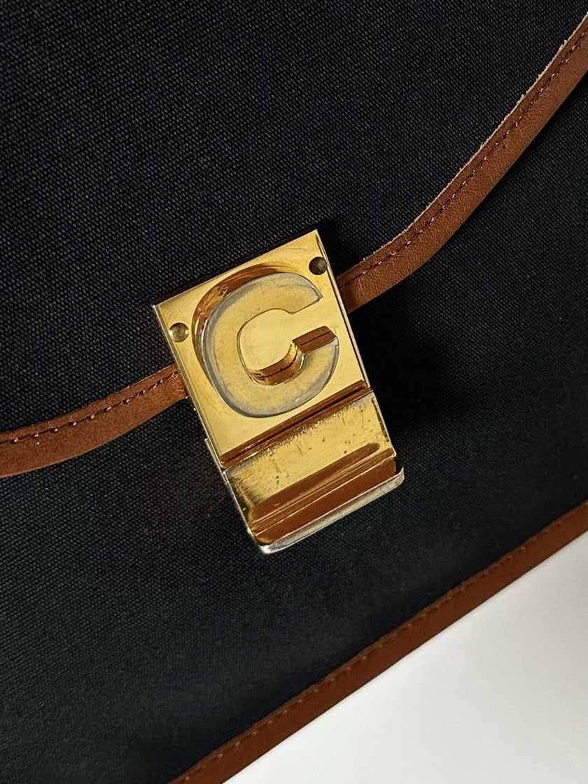 Pochette vintage Celine modello a busta in canvas nero con profili in pelle tabacco