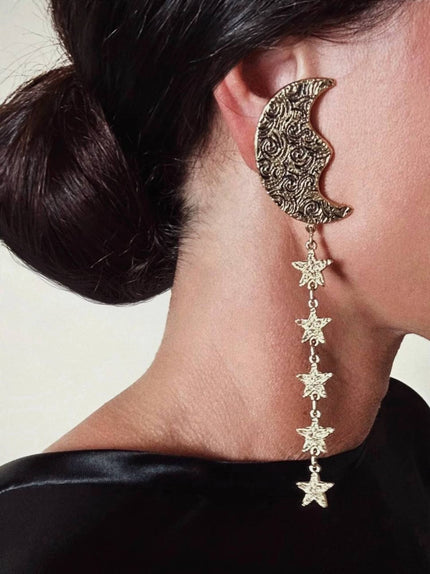 Orecchini vintage Yves Saint Laurent con lune e stelle pendenti dorate