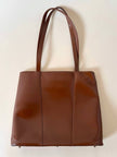 Borsa Yves Saint Laurent in pelle spazzolata color cuoio con accessorio gioiello