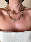 Cintura/collana dorata composta da greche e teste di leone