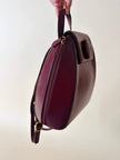 Sac à dos Must de Cartier en cuir bordeaux avec finitions dorées