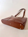Borsa Yves Saint Laurent in pelle spazzolata color cuoio con accessorio gioiello