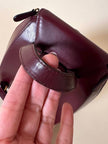 Sac à dos Must de Cartier en cuir bordeaux avec finitions dorées