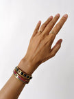 Bracciale vintage Fendi in metallo dorato con inserti in pelle nera intrecciata
