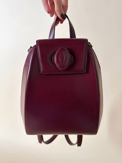 Zaino Must de Cartier in pelle bordeaux con hardware dorato