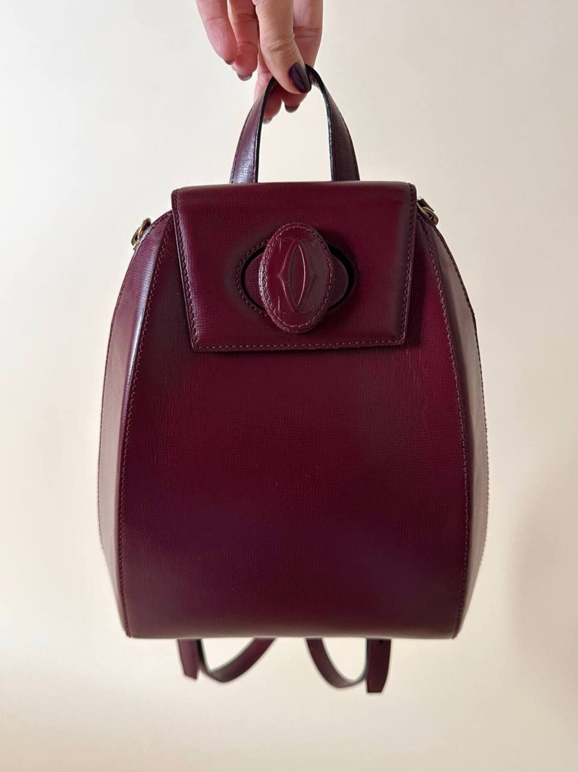 Sac à dos Must de Cartier en cuir bordeaux avec finitions dorées