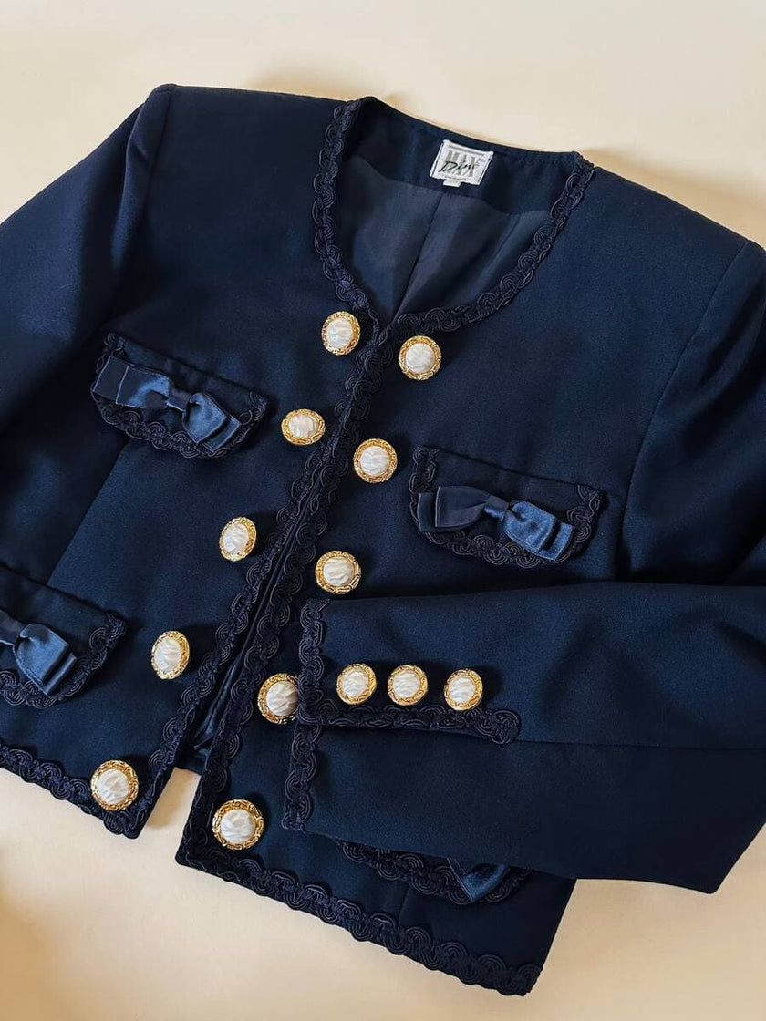 Bolero blu con bottoni gioiello e fiocchi “Max Dinè”
