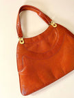 Borsa in pelle arancione zucca con doppi manici e hardware oro