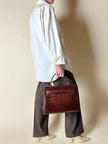 Borsa a trapezio in pelle di coccodrillo color cognac con tracolla e hardware oro Idra