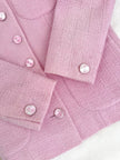 Blazer in lana bouclé rosa con bottoni gioiello logati in madreperla “Yves Saint Laurent”