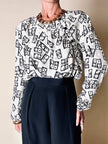 Blusa Yves Saint Laurent in tessuto jacquard bianco e nero fantasia Domino