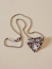 Collier argento con ciondolo a forma di cuore e cristalli incastonati “Yves Saint Laurent”